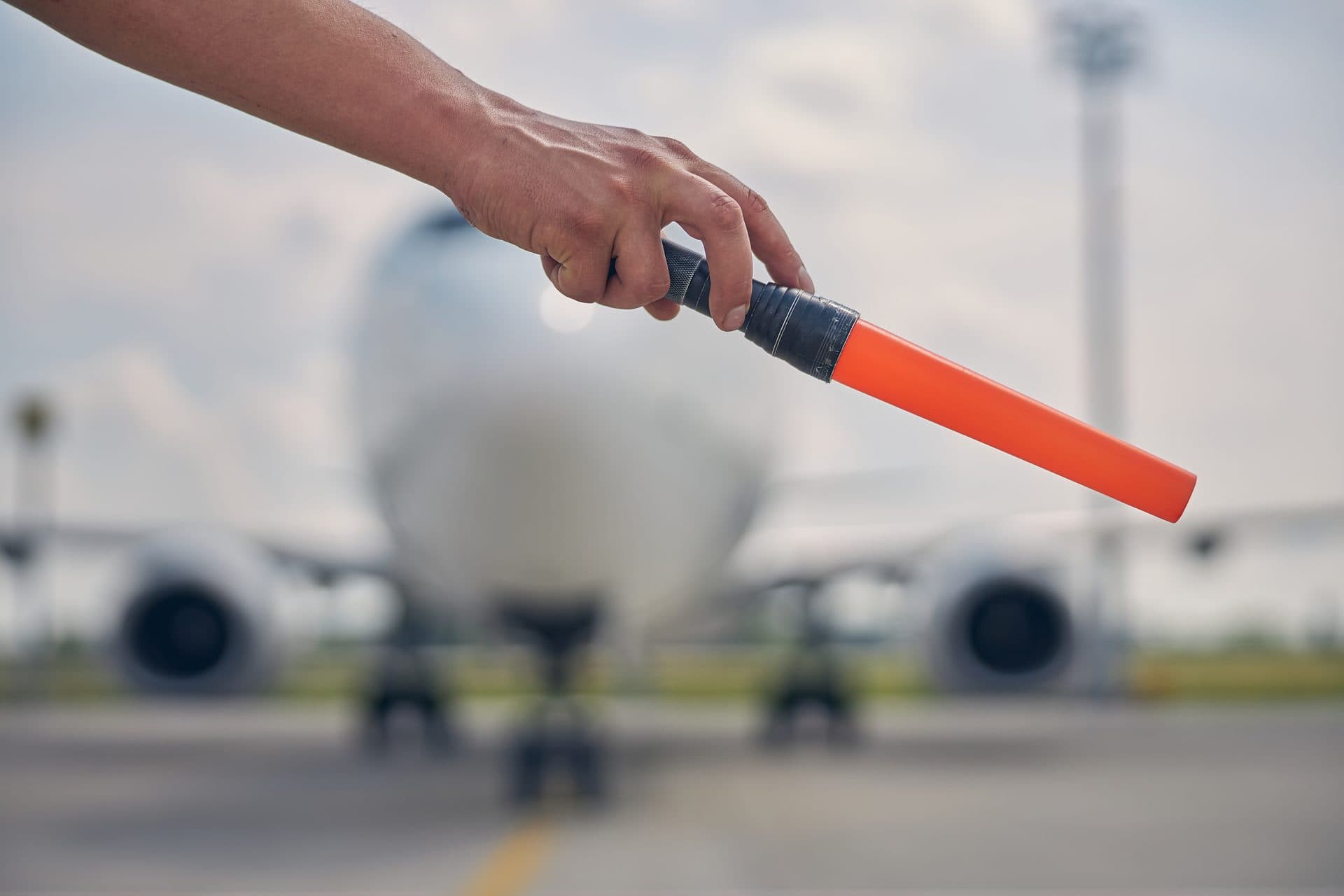 Ground handler marshalling aircraft